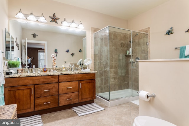 bathroom with vanity, an enclosed shower, and tile patterned floors