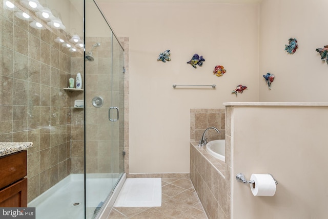 bathroom with independent shower and bath, vanity, and tile patterned floors