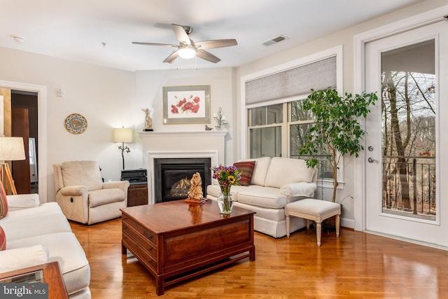 living room featuring ceiling fan and hardwood / wood-style flooring