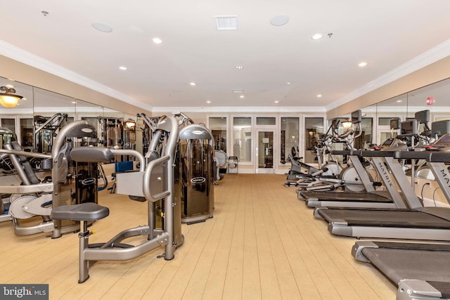 workout area featuring light hardwood / wood-style flooring and crown molding