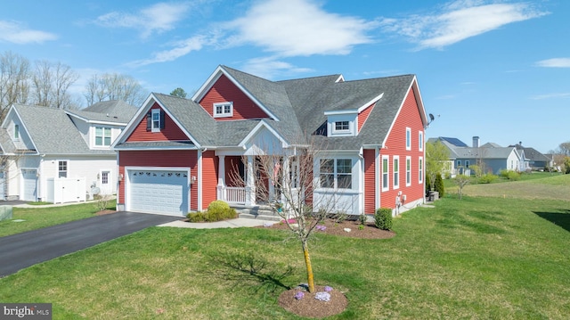 view of front of property with a front lawn, covered porch, and a garage