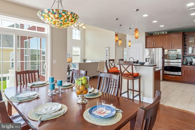 dining space featuring a chandelier and light hardwood / wood-style floors