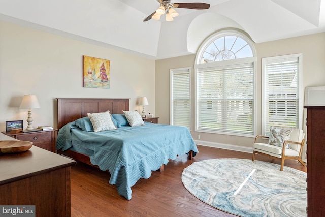 bedroom featuring dark hardwood / wood-style flooring, vaulted ceiling, and ceiling fan