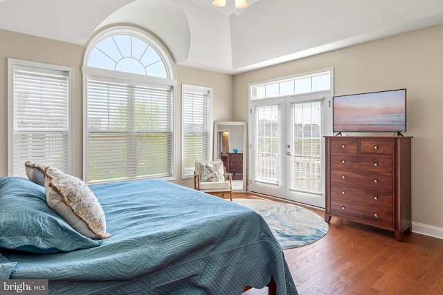 bedroom with hardwood / wood-style floors, french doors, access to outside, and multiple windows