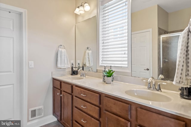 bathroom featuring vanity and an enclosed shower