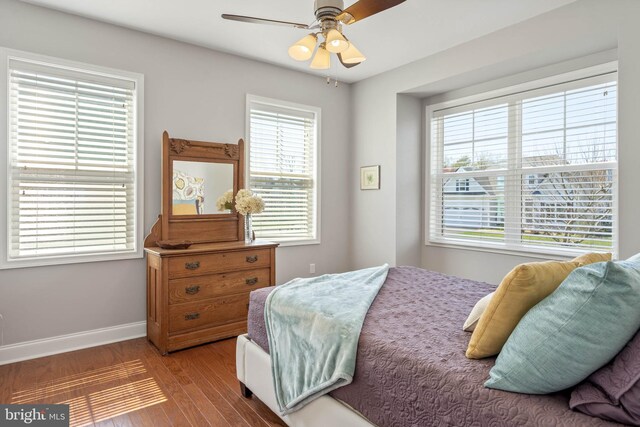 bedroom with hardwood / wood-style floors and ceiling fan