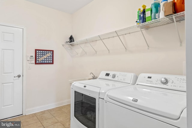 laundry area with washing machine and dryer, sink, and light tile patterned flooring