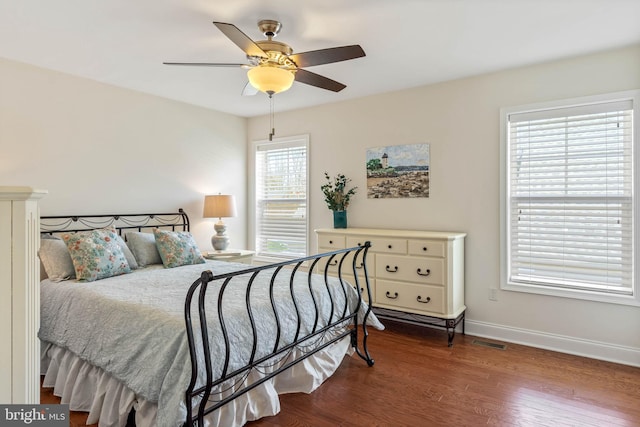 bedroom with hardwood / wood-style floors, multiple windows, and ceiling fan