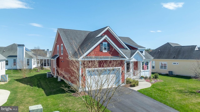 view of front of property with a garage and a front lawn