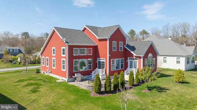 rear view of property featuring a yard