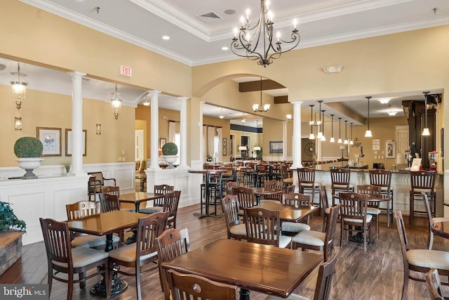 dining area featuring a chandelier, dark hardwood / wood-style floors, a tray ceiling, and crown molding