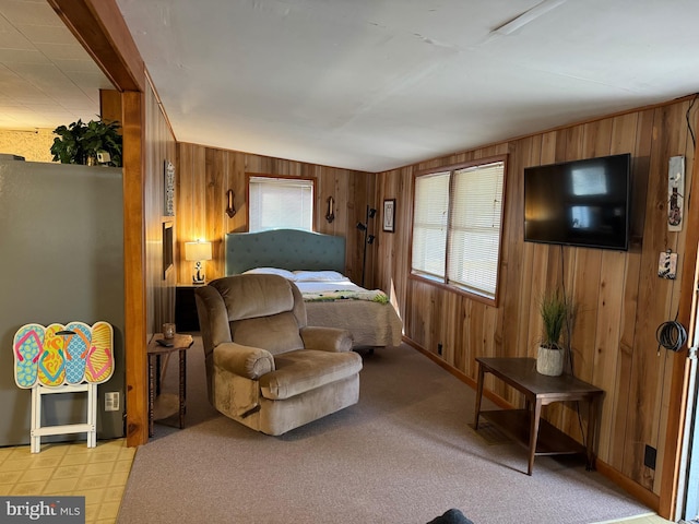 carpeted bedroom with wood walls