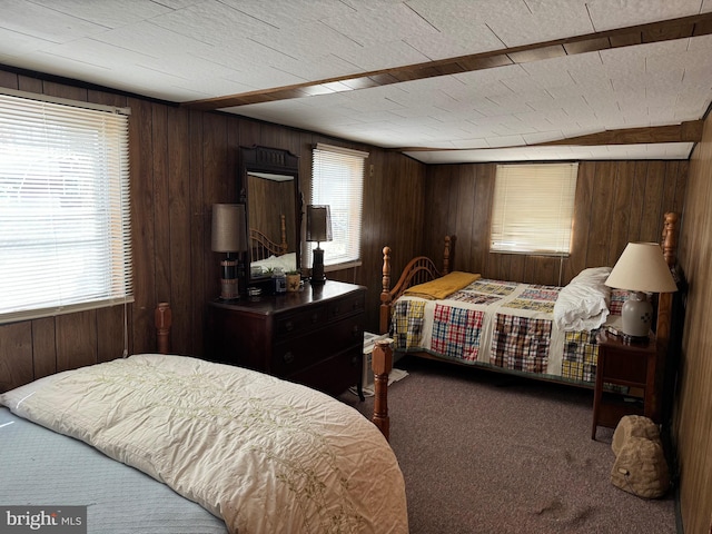 carpeted bedroom featuring wood walls