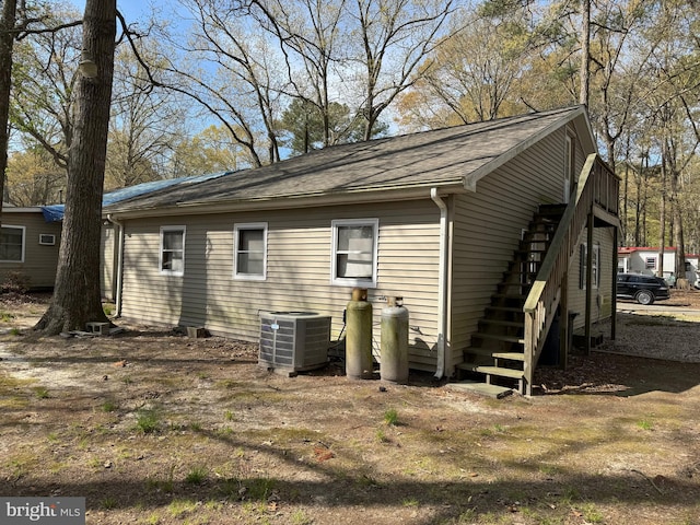 back of house featuring central air condition unit