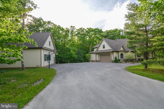 view of front of house with a front lawn and a garage