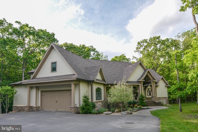 view of front of property featuring a front yard and a garage