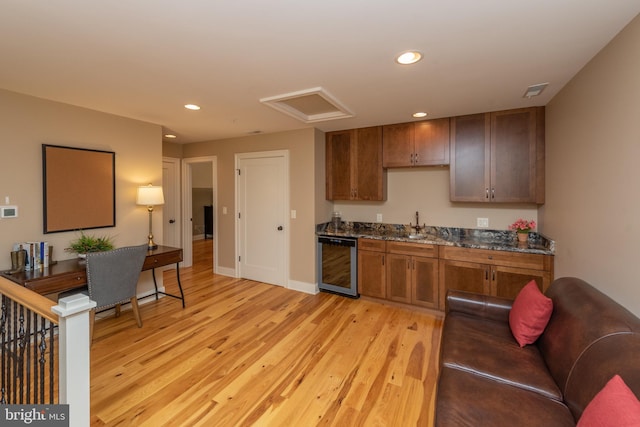 kitchen with wine cooler and light wood-type flooring