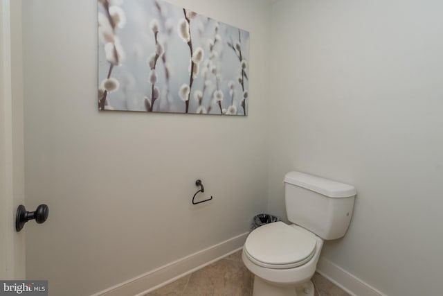 bathroom with toilet and tile flooring