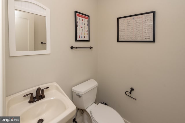 bathroom featuring toilet and sink