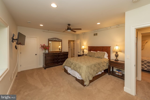 bedroom with ceiling fan and light carpet