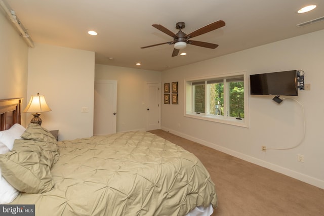 bedroom featuring light carpet and ceiling fan