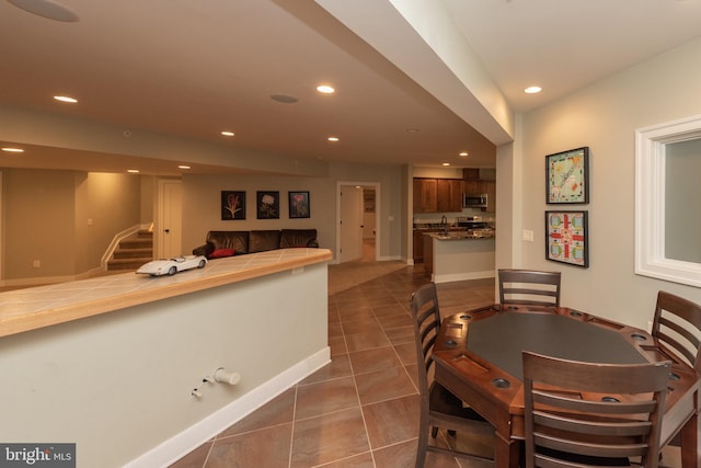 dining space featuring dark tile floors