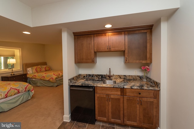 kitchen with dark stone countertops, sink, dark carpet, and black dishwasher