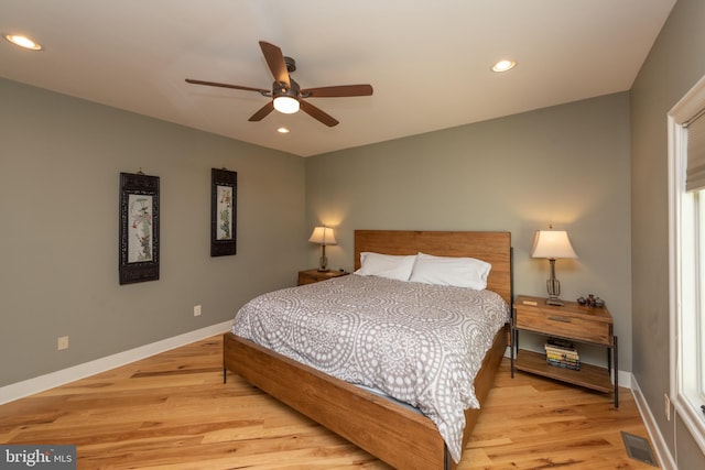 bedroom with light hardwood / wood-style floors and ceiling fan