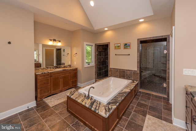 bathroom with vanity with extensive cabinet space, tile floors, shower with separate bathtub, and lofted ceiling