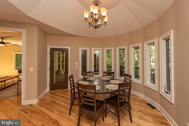 dining space featuring ceiling fan with notable chandelier, plenty of natural light, and light hardwood / wood-style flooring