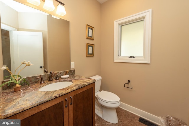 bathroom featuring tile flooring, oversized vanity, and toilet