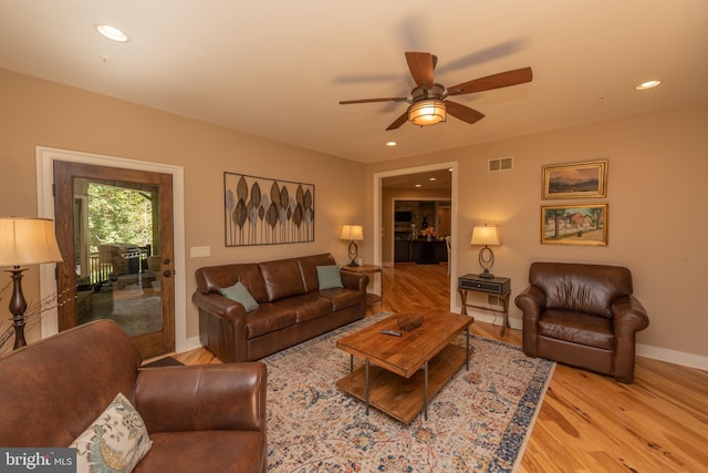 living room featuring ceiling fan and light wood-type flooring