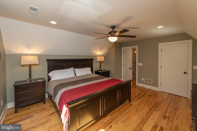 bedroom with light hardwood / wood-style floors, ceiling fan, and vaulted ceiling