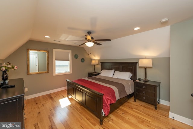 bedroom with lofted ceiling, ceiling fan, and light wood-type flooring