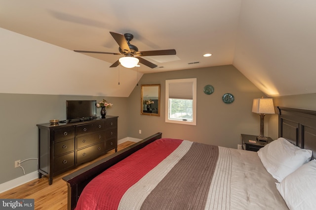 bedroom featuring light hardwood / wood-style flooring, ceiling fan, and lofted ceiling