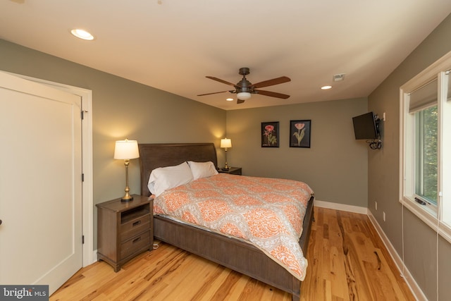 bedroom with light hardwood / wood-style flooring and ceiling fan