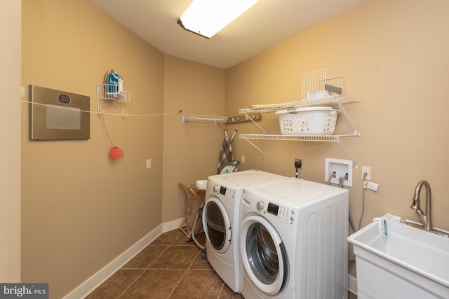 washroom with hookup for a washing machine, separate washer and dryer, dark tile flooring, electric dryer hookup, and sink