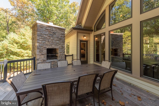 deck featuring an outdoor stone fireplace