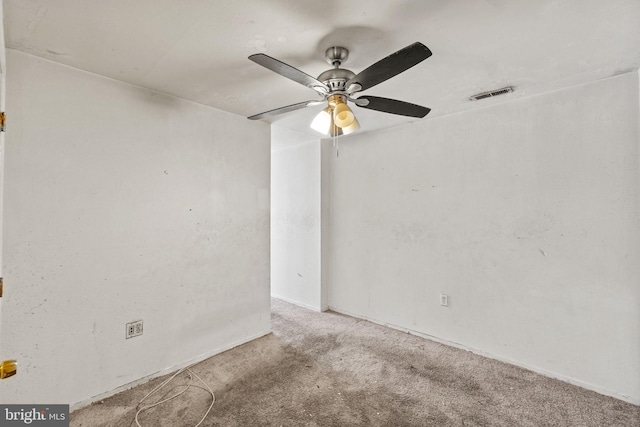 carpeted spare room featuring ceiling fan