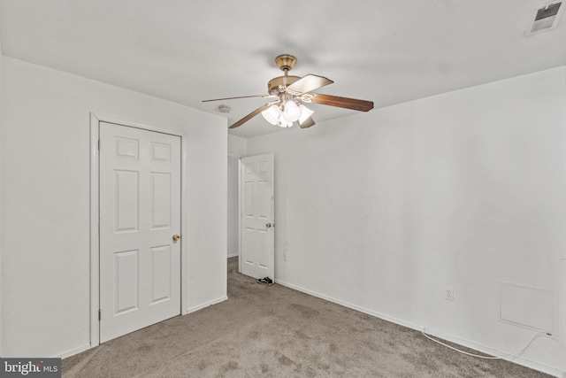 unfurnished bedroom featuring light carpet and ceiling fan