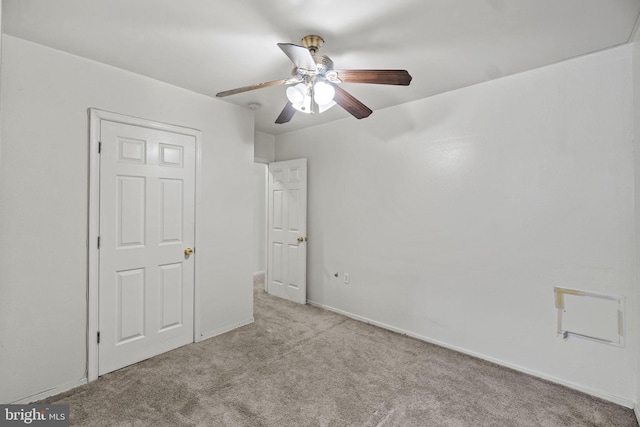 unfurnished bedroom featuring light carpet and ceiling fan