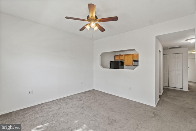 empty room with light colored carpet and ceiling fan