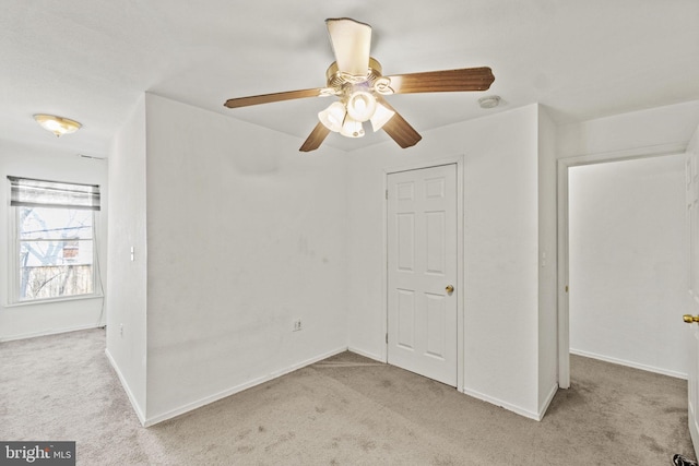 carpeted empty room with ceiling fan