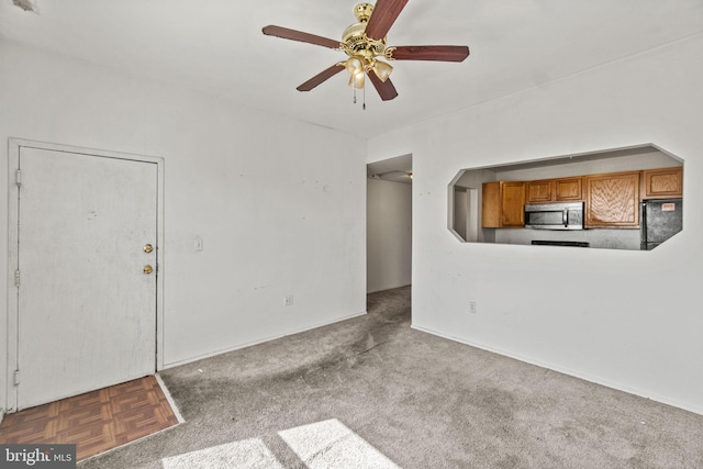 unfurnished living room with ceiling fan and carpet floors