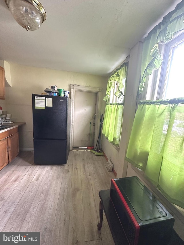 interior space with sink and light wood-type flooring