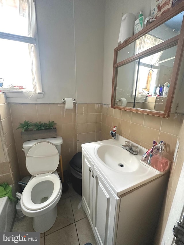 bathroom featuring tile walls, toilet, tasteful backsplash, vanity, and tile floors