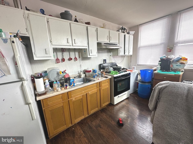 kitchen with white cabinets, sink, white appliances, and dark hardwood / wood-style floors