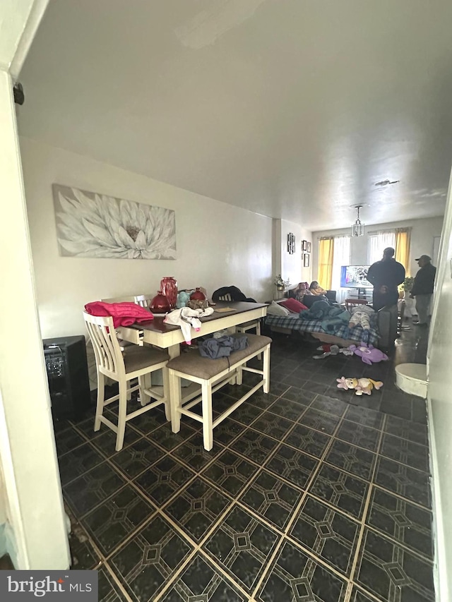 dining space with dark tile floors