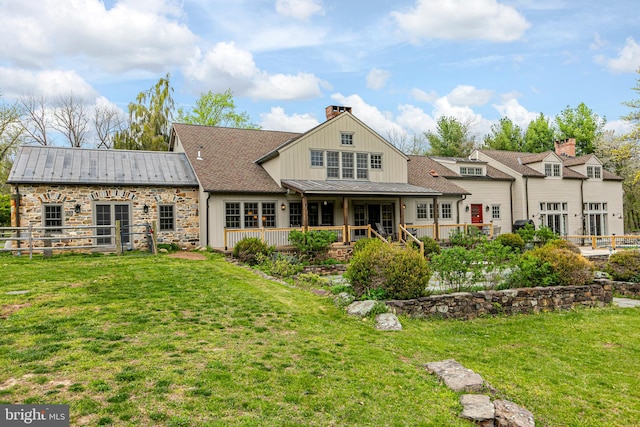 back of house featuring a lawn