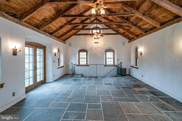 unfurnished room featuring wood ceiling, ceiling fan, and dark tile floors